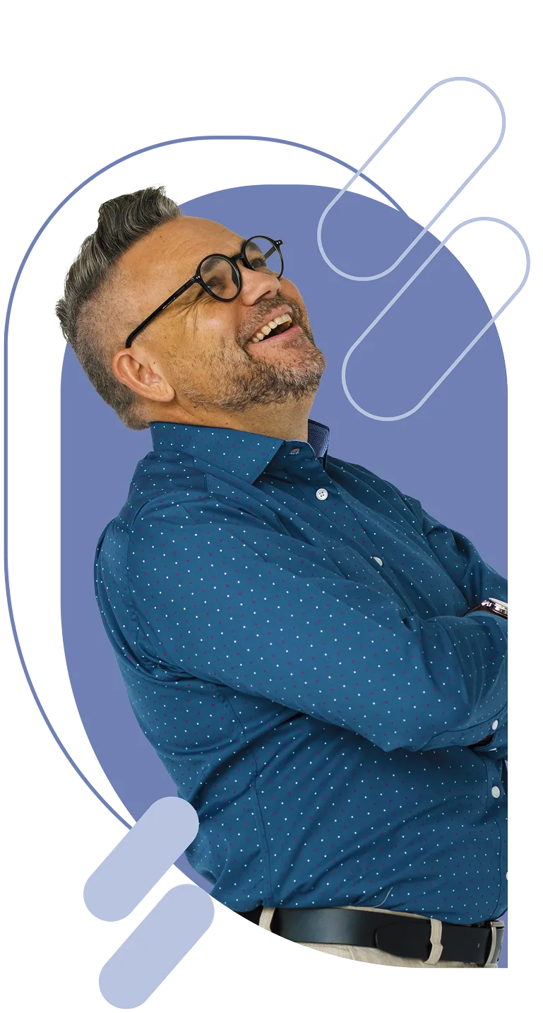 Man wearing blue shirt with dots smiling