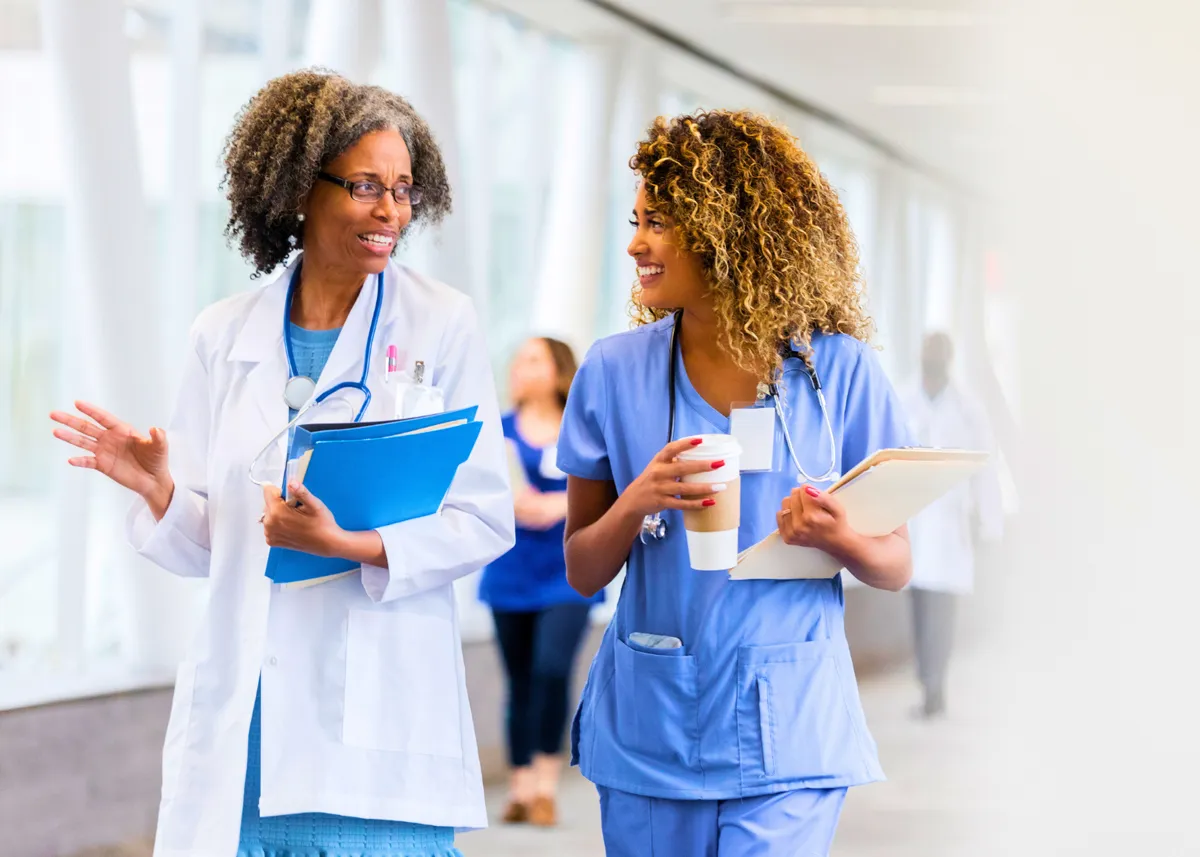 two female physicians walking